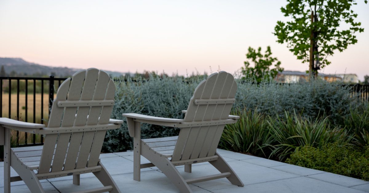 Two outdoor chairs on a garden patio at dusk, prime mosquito time in a Sydney summer