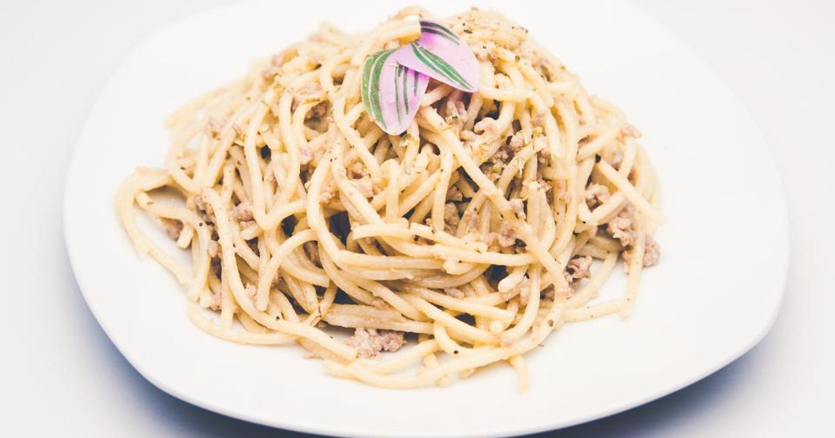 A plate of spaghetti on a white table
