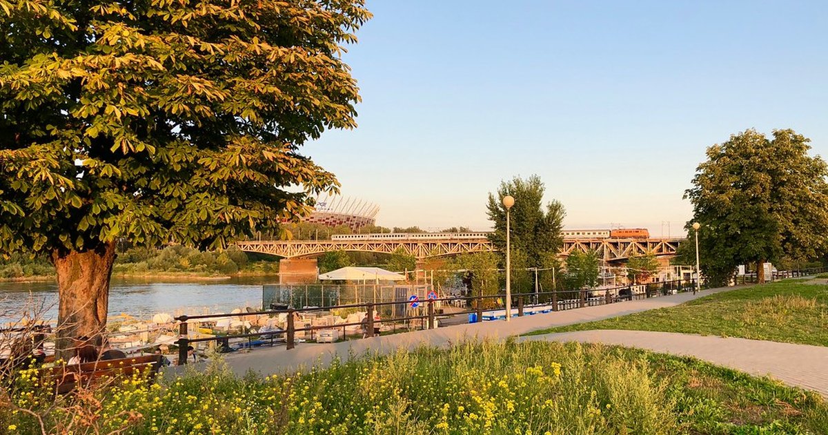 A riverside park on a clear, sunny afternoon
