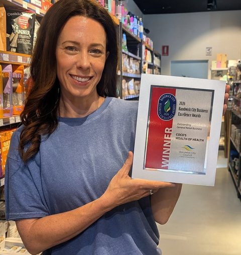 Coco holding the 2026 Randwick City Business Excellence Award for Outstanding General Retail Business